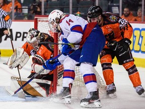 Calgary Hitmen goaltender Brayden Peters makes a save against Edmonton Oil Kings forward Marshall Finnie during the Every Child Matters Game at Scotiabank Saddledome in Calgary on Saturday, Feb. 4, 2023. The Hitmen lost 5-1.