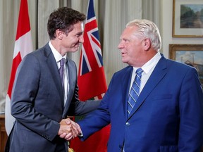 Prime Minister Justin Trudeau shakes hands with Ontario Premier Doug Ford at Queen's Park in Toronto August 30, 2022.