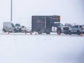 Police investigate at the scene where a dozen vehicles were damaged in a pileup on Stoney Trail between McKnight Blvd. and 16th Avenue N.E. after snow flurries swept through Calgary on Tuesday, February 28, 2023. There were no serious injuries in the crash.
