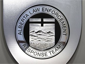 The Alberta Law Enforcement Response Teams (ALERT) logo is pictured.