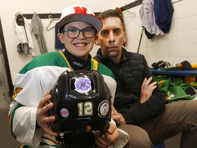 Chris Snow with son Cohen and U13 Gold Northstar’s teammates are participating in a sticker campaign to fundraise for ALS in Calgary on Saturday, February 25, 2023.