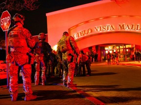 Law enforcement members gather outside the Cielo Vista Mall after a shooting, in El Paso, Texas, Wednesday, Feb. 15, 2023.