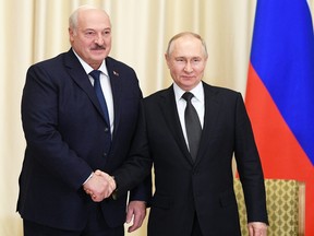 Russian President Vladimir Putin shakes hands with Belarusian President Alexander Lukashenko during a meeting at the Novo-Ogaryovo state residence outside Moscow, Russia, Feb. 17, 2023.