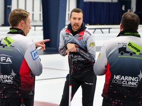 Skip Brendan Bottcher (centre) chats with teammate Marc Kennedy (left) and coach Paul Webster during a practice at The Glencoe Club in Calgary on Jan. 25, 2023.