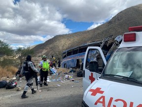 Puebla's Red Cross paramedics work at the scene of a bus accident which was carrying migrants from Venezuela, Colombia and Central America, in Cuacnopalan, Mexico February 19, 2023.