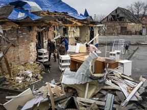 Health workers and local residents salvage furniture from a community clinic that was destroyed in a rocket attack on February 26, 2023 in Kramatorsk, Ukraine.