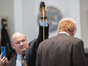 Defence attorney Jim Griffin measures Alex Murdaugh during a break in his double murder trial at the Colleton County Courthouse in Walterboro, S.C., Thursday, Feb. 16, 2023.