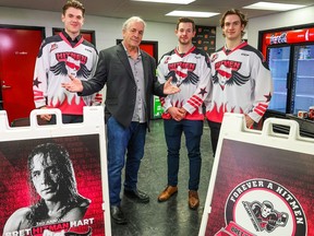 Bret Hart poses with Calgary Hitmen players, from left, Tyson Galloway, Riley Fiddler-Schultz and Sean Tschigerl on Monday, Feb. 13, 2023 as they promote the third annual Bret ‘Hitman’ Hart game in partnership with the Calgary Prostate Cancer Centre. The game will take place on Saturday, March 11, 2023.