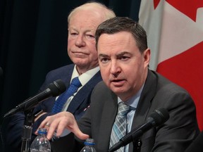 Health Minister Jason Copping provided updates on the work underway to reduce wait times and improve patient care in Alberta during a press conference at the McDougall Centre in Calgary on Monday, February 27, 2023. Dr. John Cowell listens in the background.