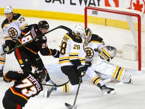 Boston Bruins goaltender Linus Ullmark makes a save as Calgary Flames forwards 
Tyler Toffoli and Elias Lindholm battle Bruins defencemen Derek Forbort and Charlie McAvoy at the Scotiabank Saddledome in Calgary on Tuesday, Feb. 28, 2023