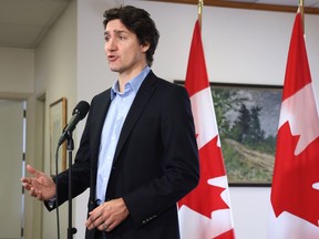 Prime Minister Justin Trudeau speaks to the media Sunday, February 12, 2023, in Ottawa before boarding a flight to the Yukon.