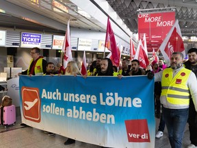 Protesters and members of trade union ver.di demonstrate as they stage a strike, at Frankfurt Airport in Frankfurt am Main, western Germany, on Feb. 17, 2023.