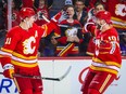 Feb 18, 2023; Calgary, Alberta, CAN; Calgary Flames center Mikael Backlund (11) celebrates his goal with center Jonathan Huberdeau (10) during the overtime period against the New York Rangers at Scotiabank Saddledome. Mandatory Credit: Sergei Belski-USA TODAY Sports