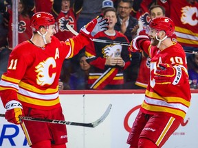 Feb 18, 2023; Calgary, Alberta, CAN; Calgary Flames center Mikael Backlund (11) celebrates his goal with center Jonathan Huberdeau (10) during the overtime period against the New York Rangers at Scotiabank Saddledome. Mandatory Credit: Sergei Belski-USA TODAY Sports