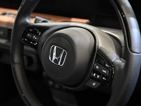 In this file photo taken on Nov. 6, 2020, a Honda logo is pictured from a displayed car at a Honda showroom of companys headquarters in Tokyo.