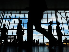 People walk through international arrivals at Terminal 4 at John F. Kennedy (JFK) airport on June 26, 2017 in New York City.