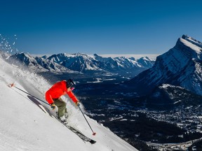 Andre Quenneville cranks turns down Boundary Bowl at Banff’s Mt. Norquay, with Mount Rundle and the Town of Banff in the background.