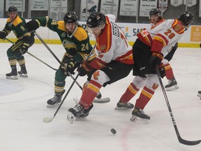 Riley Krane fights for the puck against Jake Gricius during University hockey action between the University of Regina Cougars and University of Calgary Dinos at the Co-operators Centre on Thursday, January 19, 2023 in Regina.