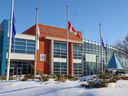 Flags are flown at half-mast at Calgary Police Service headquarters after two Edmonton police officers were shot dead on Thursday, March 16, 2023.