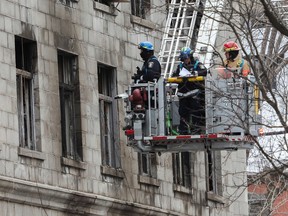 Police investigators look inside a building in Old Montreal on March 19, the site of a fatal fire that took place a few days earlier.