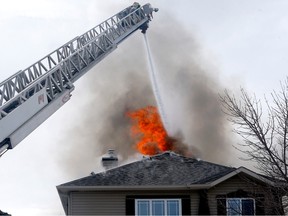 Calgary fire battle two homes on fire on Citadel Way N.W. in Calgary on Friday, March 24, 2023.