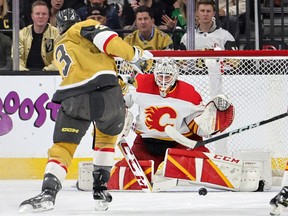 Calgary Flames goalie Jacob Markstrom blocks a shot from Vegas Golden Knights defenseman Braden McNabb at the T-Mobile Arena in Las Vegas on Thursday, March 16, 2023.