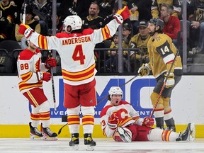 Calgary Flames forward Tyler Toffoli (right) celebrates a goal against the Vegas Golden Knights with Andrew Mangiapane and Rasmus Andersson at T-Mobile Arena in Las Vegas on 
Thursday, March 16, 2023.