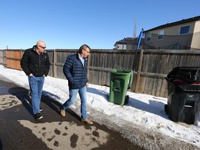 Calgary police homicide detectives examine an alley in the 300 block of Martindale Drive N.E. in Calgary on Tuesday, March 28, 2023. A 15-year-old girl was fatally shot.