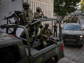 Armoured vehicles leave the Attorney General's Office for Special Investigations on Organized Crime (FEMDO) in Mexico City, on January 5, 2023, after the arrest of Ovidio Guzman, son of imprisoned drug trafficker Joaquin "El Chapo" Guzman.