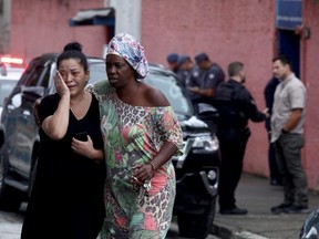 Silvia Palmieri, mother of a teacher, reacts as she leaves Thomazia Montoro school, where a teenager stabbed three teachers and two students, in Sao Paulo, Brazil, Monday, March 27, 2023.
