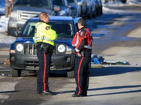 Calgary police investigate at the scene where a child was seriously injured after being hit by a vehicle on Royal Oak Drive on Monday, March 20, 2023.