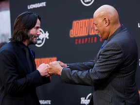 Cast members Keanu Reeves and Laurence Fishburne attend the premiere for the film "John Wick: Chapter 4", in Los Angeles, March 20, 2023.