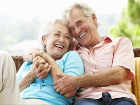 Older couple with arms wrapped around one another and smiling