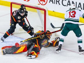 Calgary Flames goaltender Jacob Markstrom (25) makes a save against Minnesota Wild centre Sam Steel (13) during the first period at the Scotiabank Saddledome on Saturday, March 4, 2023.