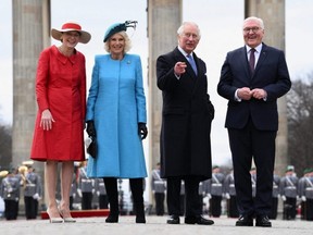 German President Frank-Walter Steinmeier (right), his wife Elke Buedenbender (left) and Britain's King Charles and Camilla, the Queen Consort attend a welcome ceremony with military honors at Pariser Platz square in front of Brandenburg Gate in Berlin, Germany, Wednesday, March 29, 2023.