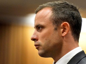 Oscar Pistorius stands in the dock during his murder trial at the North Gauteng High Court in Pretoria, South Africa, March 3, 2014.