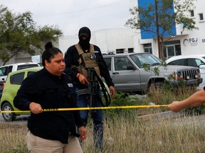 Security forces setup a yellow cordon outside the Forensic Medical Service morgue building ahead of the transfer of the bodies of two of four Americans kidnapped by gunmen to the U.S. border, in Matamoros, Mexico, March 9, 2023.