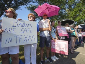 Linda Banes, left, and Ethelene Marshall stand with anti-abortion demonstrators as they gathered to sing and pray outside Planned Parenthood in Houston, June, 24, 2022, after the U.S. Supreme Court overturned Roe v Wade.