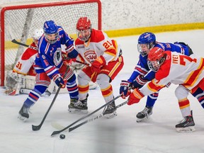 The Calgary Flames and Calgary Buffaloes battle during the deciding Game 5 of their Alberta Elite Hockey League U18AAA South Division championship series at Cardel Rec South in Calgary on Sunday, March 19, 2023.