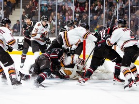 The Calgary Hitmen and Red Deer Rebels battle during Game 1 of their WHL Eastern Conference quarterfinal series at the Peavey Mart Centrium in Red Deer on Friday, March 31, 2023.