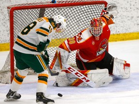 Calgary Dinos goaltender Carl Tetachuk stops Alberta Golden Bears forward Ryan Hughes in Game 1 of their Canada West championship series at Father David Bauer Arena in Calgary on Friday, March 3, 2023. The Dinos won this contest 3-2, dropped Game 2 of the series by a 5-4 count in overtime, and won the deciding Game 3 in a 2-1 decision.