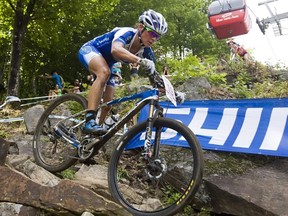 Katerina Nash, of the Czech Republic, races in the UCI women's cross country world cup on Sunday, Aug. 3, 2014, at the UCI mountain bike world cup at Mont-Sainte-Anne in Beaupre, Quebec.