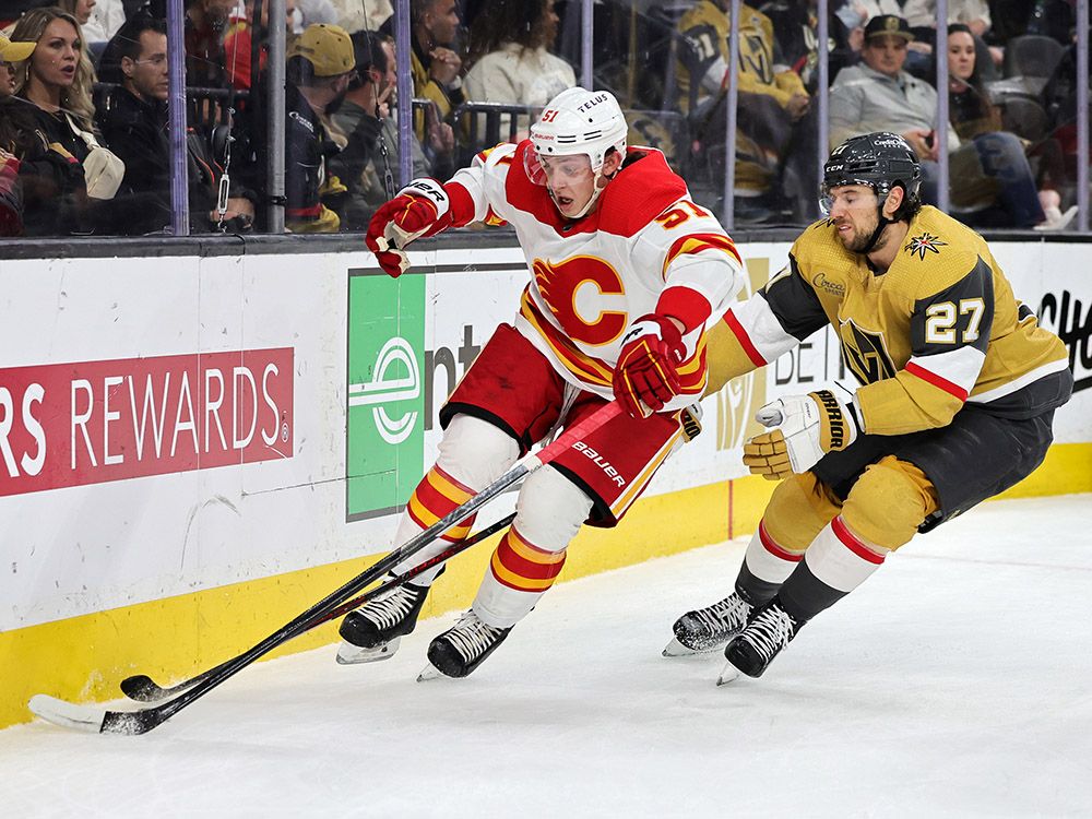 Troy Stecher defends against Shea Theodore during a game against the Vegas Golden Knights on March 16.