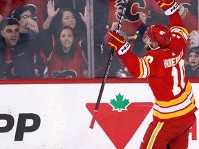 Calgary Flames forward Jonathan Huberdeau and fans celebrate his goal against the Ottawa Senators at Scotiabank Saddledome in Calgary on Sunday, March 12, 2023.