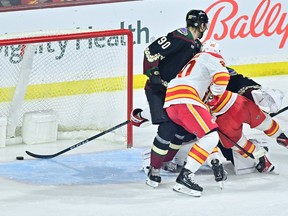 Calgary Flames forward Andrew Mangiapane (centre) scores on Arizona Coyotes goaltender Connor Ingram at Mullett Arena in Tempe, Ariz., on Tuesday, March 14, 2023.