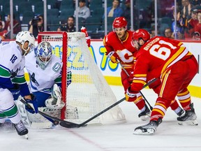 Calgary Flames forward Clark Bishop tries to score on Vancouver Canucks goaltender Michael DiPietro during a pre-season game at the Scotiabank Saddledome in Calgary on Sept. 25, 2022.