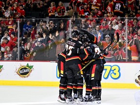 Mar 23, 2023; Calgary, Alberta, CAN; Calgary Flames center Nazem Kadri (91) celebrates with teammates after scoring a goal against the Vegas Golden Knights during the third period at Scotiabank Saddledome. Mandatory Credit: Brett Holmes-USA TODAY Sports