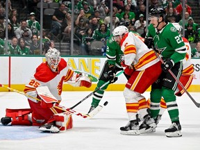 Calgary Flames goaltender Jacob Markstrom turns aside a shot as Dallas Stars forward Mason Marchment looks for the rebound at American Airlines Center in Dallas on Monday, March 6, 2023.