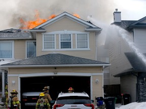 Calgary firefighters battle two homes on fire on Citadel Way N.W. in Calgary on Friday, March 24, 2023.