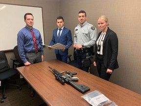 From left to right: Const. Stefan Ciccone, Crown prosecutor Alyx Nanji, Const. Mitchell Price and Const. Jessica Dagg. The officers are witnesses in the trial of Olds, Alta. man Reece Wadden, who faces criminal charges for pointing an airsoft imitation rifle (pictured on the table with an airsoft handgun also found in Waddell's apartment) at the set of The Last of Us, during filming in June 2022.